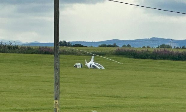 Helicopter in a field near Alness after crash landing. Image: Dylan Robertson.