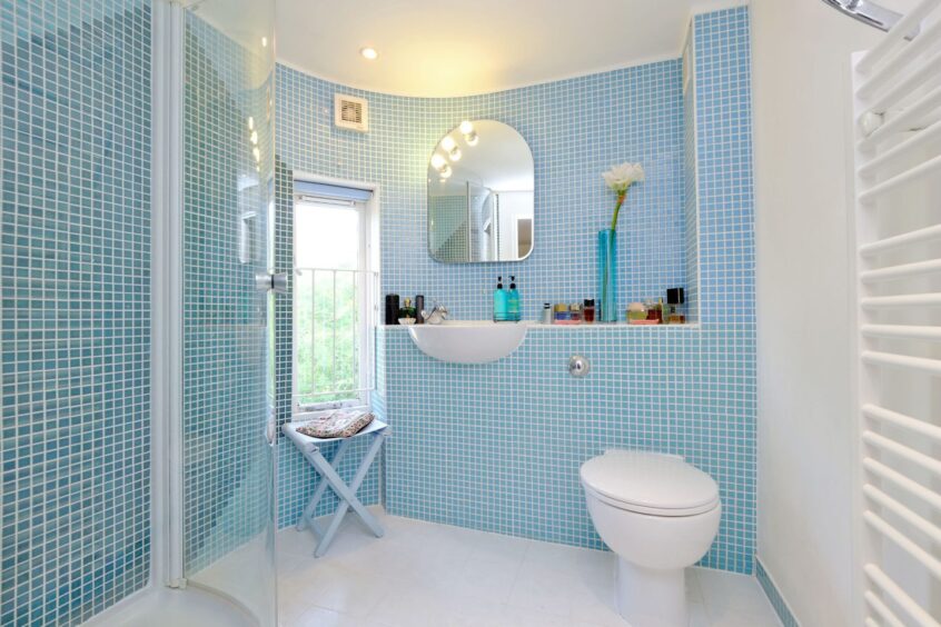 One of the bathrooms in the country home near Aberdeen, with small aqua wall tiles and white accents