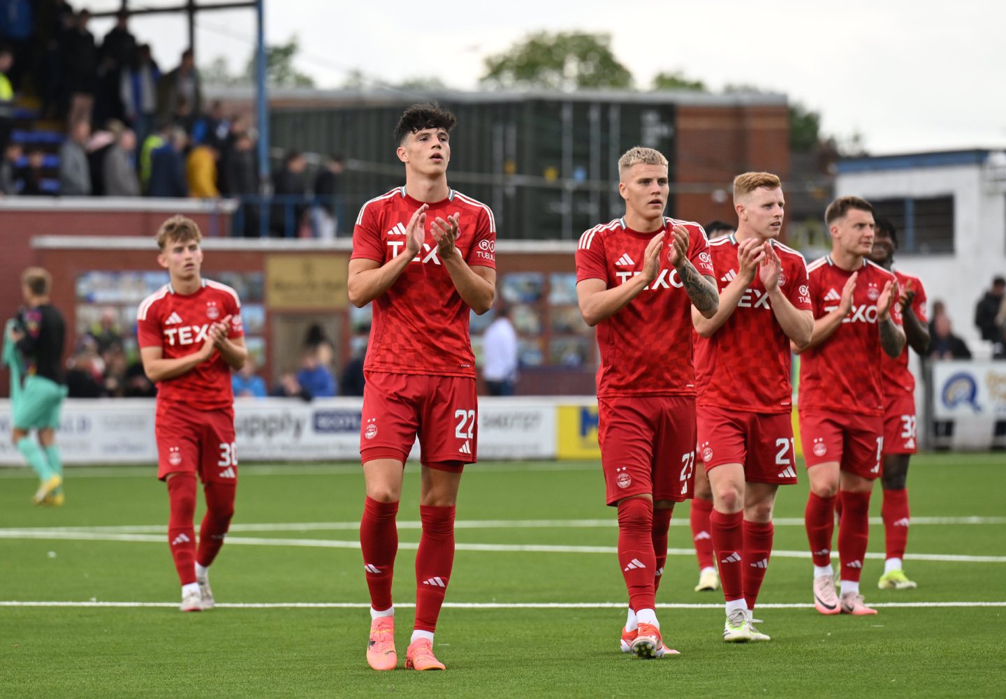 Aberdeen players applauding on the pitch