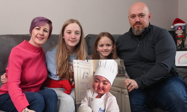 The Carneson family , from left, Lydia, Payten, Kenzi and Ryan, with a picture of their late son Reef. Image: Darrell Benns/DC Thomson.