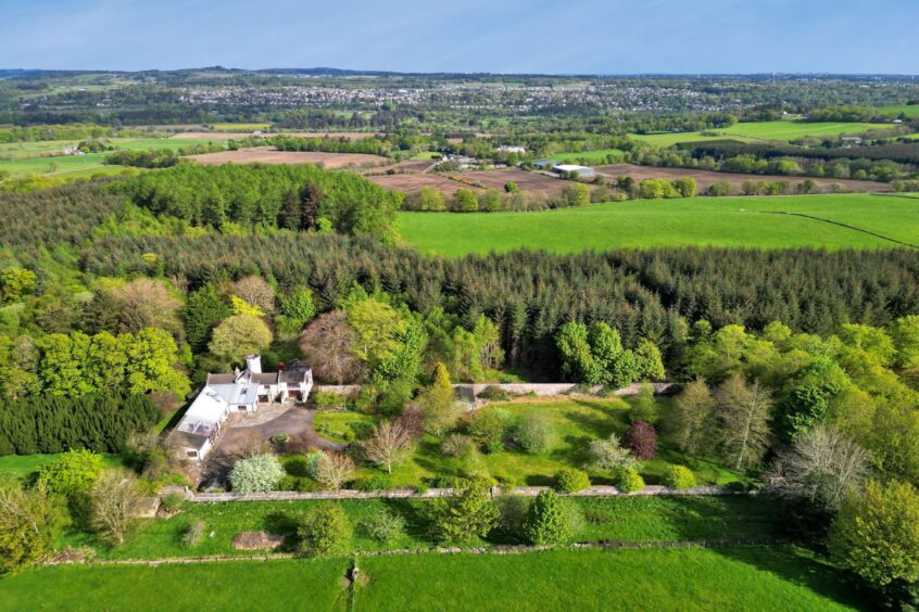 An aerial view of the home and the grounds surrounding it