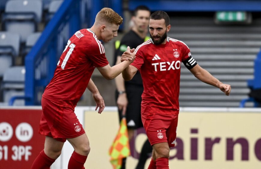 Aberdeen's Graeme Shinnie (R) celebrates making it 2-0 during a Premier Sports Cup group stage match between Queen of the South and Aberdeen at Palmerston Park, on July 13, 2024, in Dumfries, Scotland.