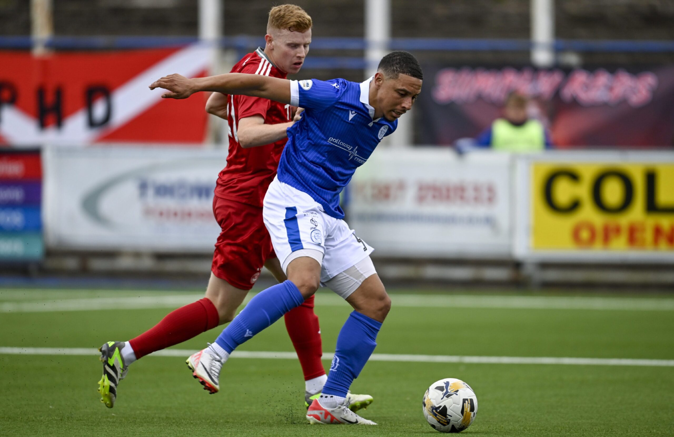  Queen of the South's Leighton McIntosh (R) and Aberdeen's Gavin Molloy in action. Image: SNS