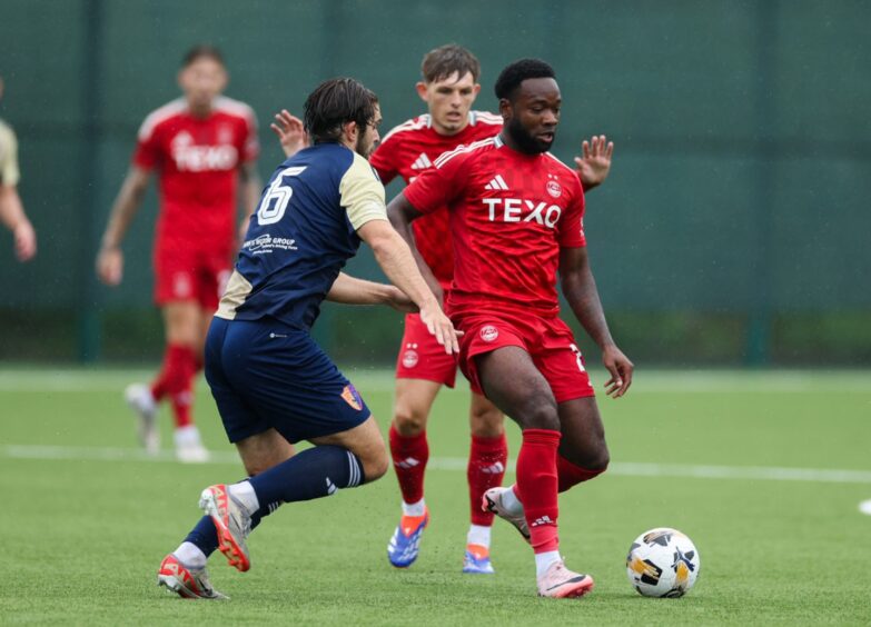 Aberdeen's Shayden Morris (R) and East Kilbride's Jack Leitch in action. Image: SNS