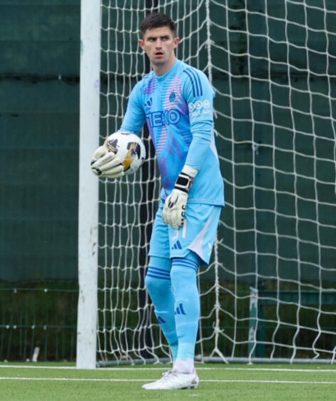 Ross Doohan in possession of the ball in goal for Aberdeen in their Premier Sports Cup match against East Kilbride.