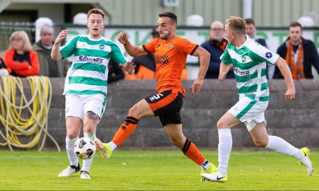 Buckie Thistle's Dale Wood, left, tries to challenge Dundee United's Vicko Sevej. Pictures by SNS Group.