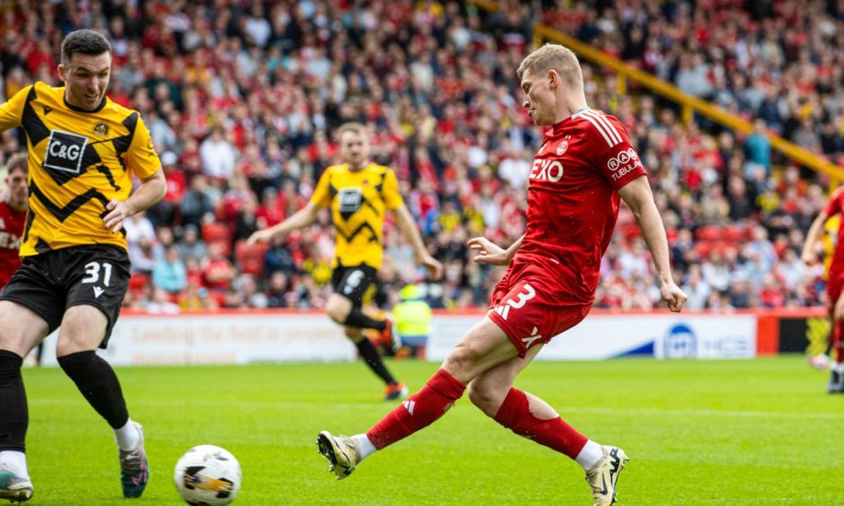 Aberdeen's Jack MacKenzie scores to make it 1-0 during a Premier Sports Cup group stage match against Dumbarton. Image: SNS. 