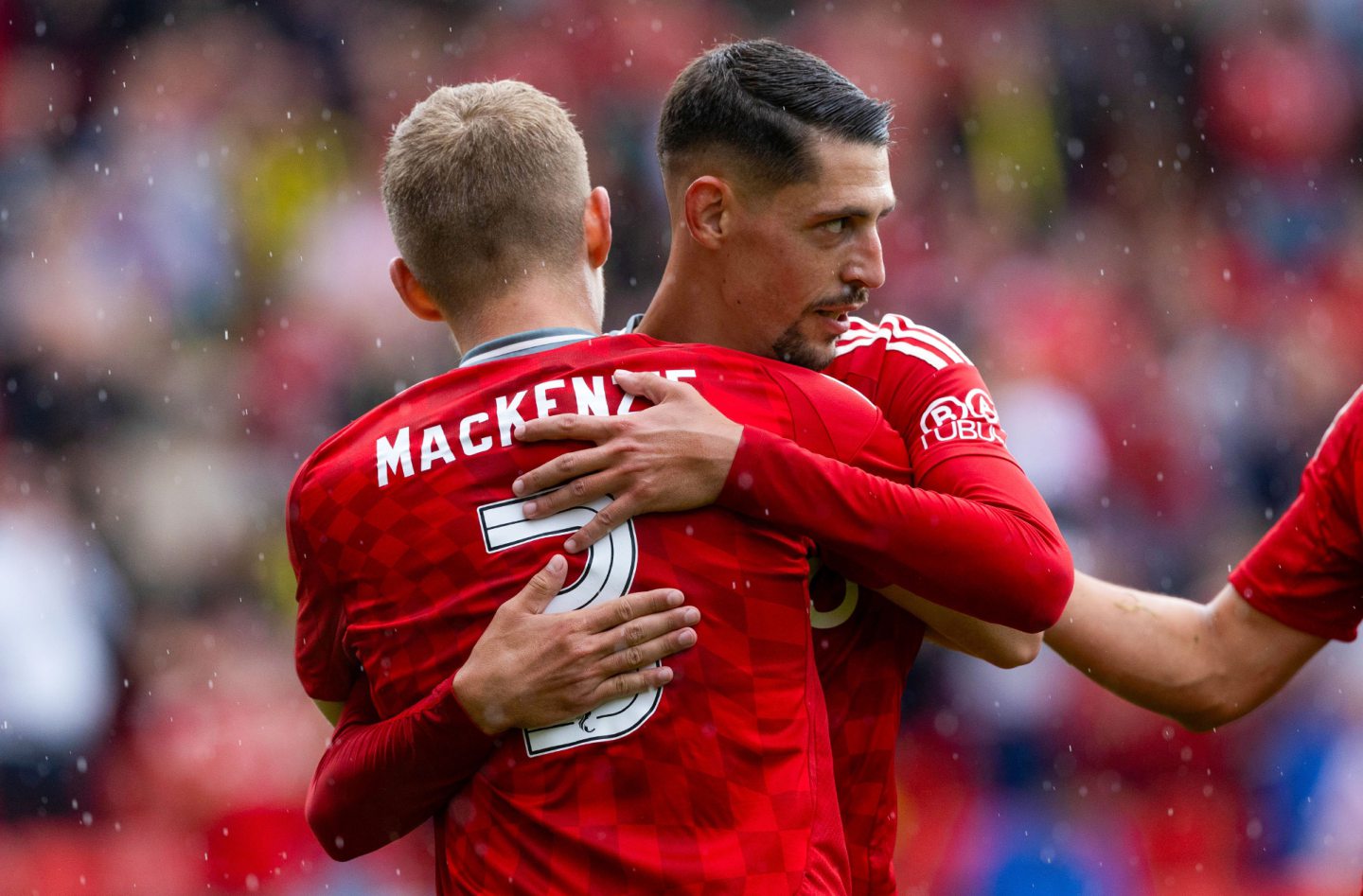 Aberdeen's Ester Sokler celebrates with Jack MacKenzie as he scores. Image: SNS 