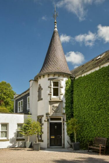 Baronial mansion with round tower in Kingswell.