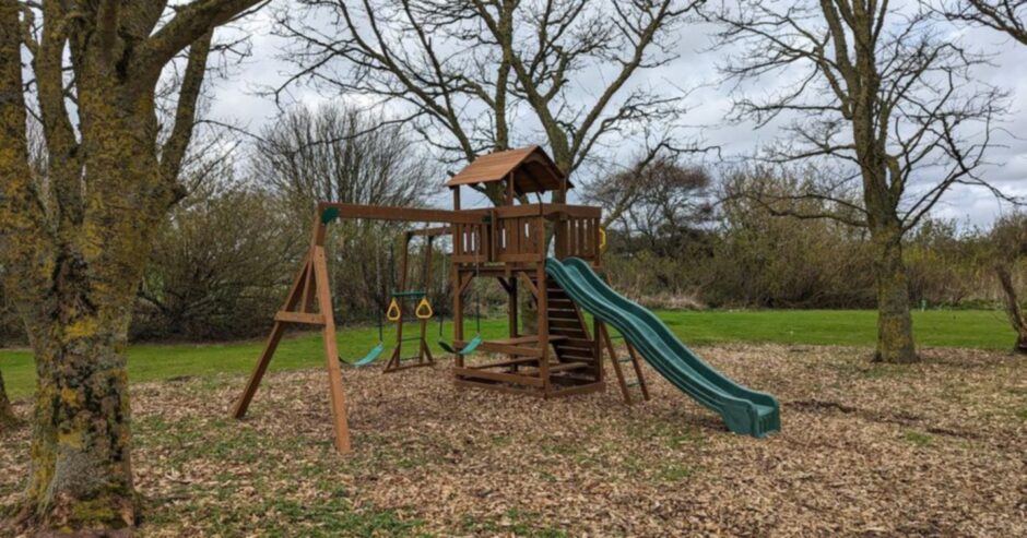 Kids climbing frame complete with swings and slide.