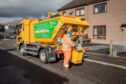 Bin lorry collections rubbish during the festive period.