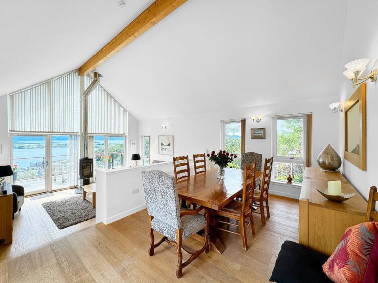 Bright living area with 'cathedral ceiling'.