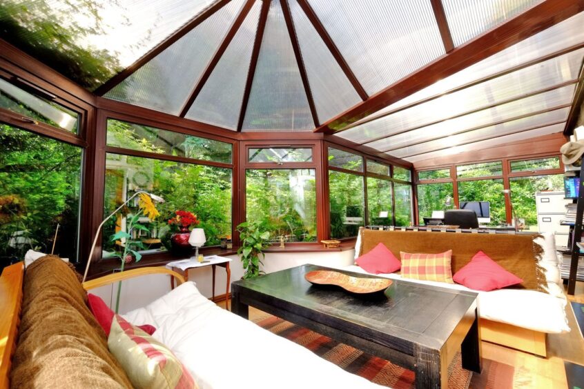 The conservatory in the Blair home, which has a desk and chair, coffee table and two sofas