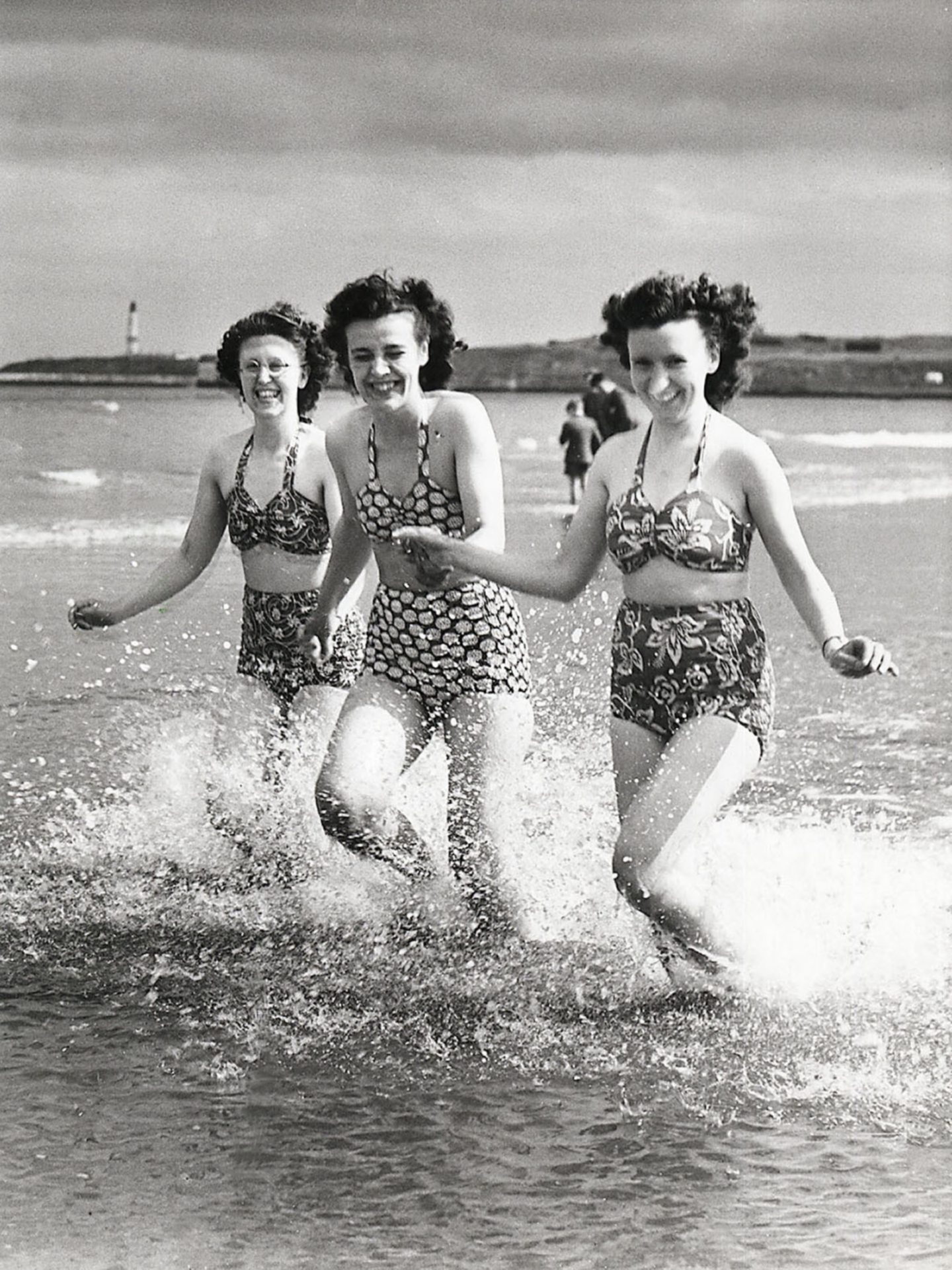 Three friends make the most of the warm sunshine on Aberdeen Beach in the 1950s.