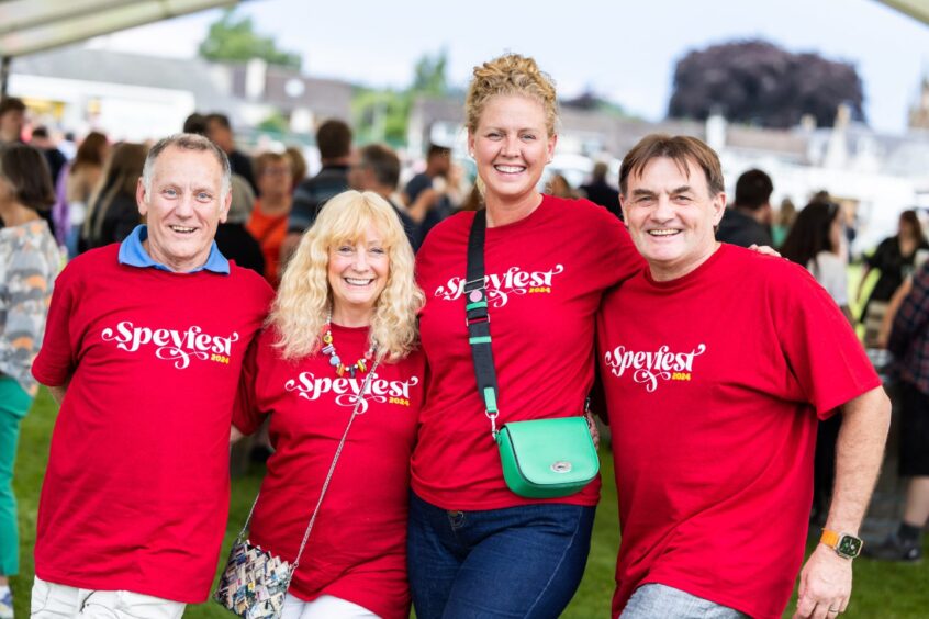 Four ladies dressed in red T-shirts at Speyfest.