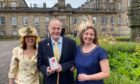 RSABI honorary vice-president Andrew Arbuckle pictured at the Palace of Holyroodhouse with daughters Lydia, left, and Elizabeth, right.