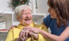 a blossom home care carer with a happy service user