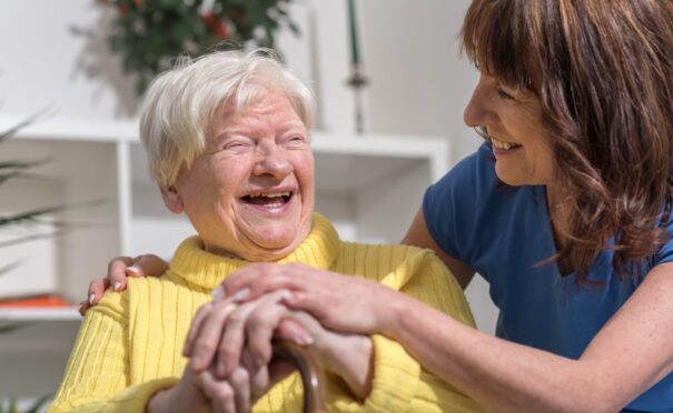 a blossom home care carer with a happy service user