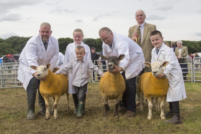 The supreme sheep championship went to Messrs Sutherland, Sibmister and Stainland Farms. Three generation of the Sutherlands lined up for the familyphoto, including grandad Kenneth, with l-r, Kenneth Jnr, Amy, Tom Stephen and Jack.