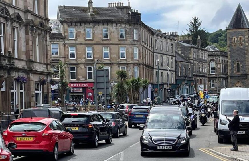 The funeral cortege outside Aulay's Bar in Oban. 