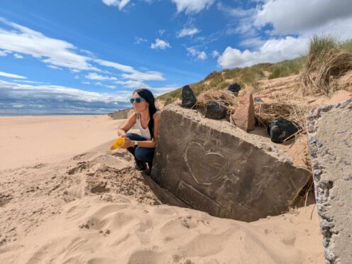 Gayle finds the fascinating tank trap on Newburgh beach with 'Hitler's Graveyard' carvings from 1940. Image: Gayle Ritchie.