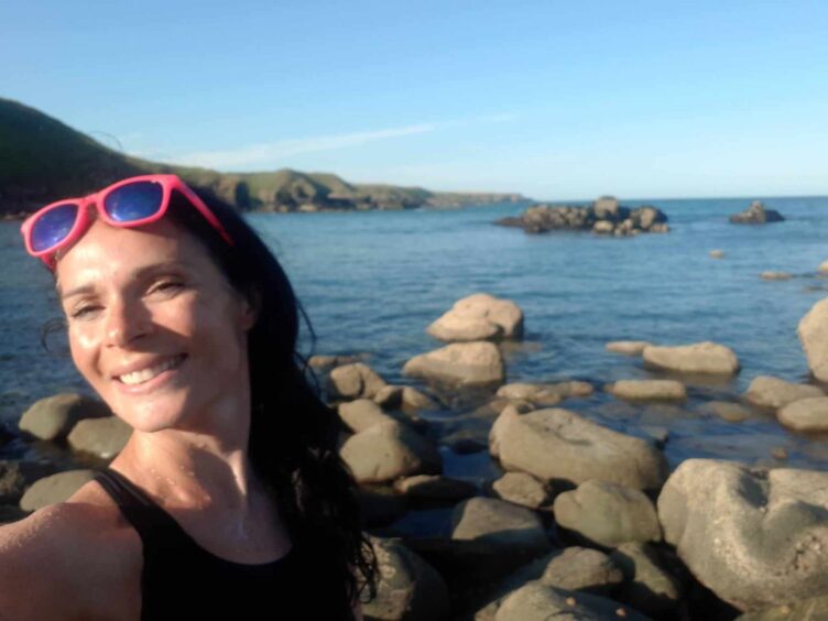 Gayle takes a dip below Old Slains Castle - perhaps not to be recommended! 