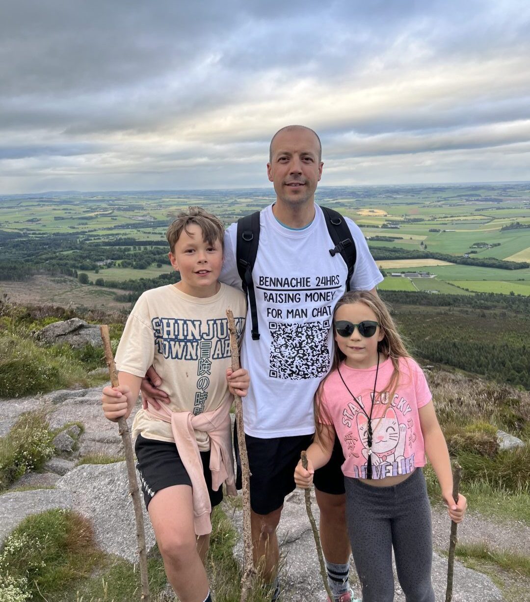 Dale McMillan with his children during the 24-hour climb of Bennachie