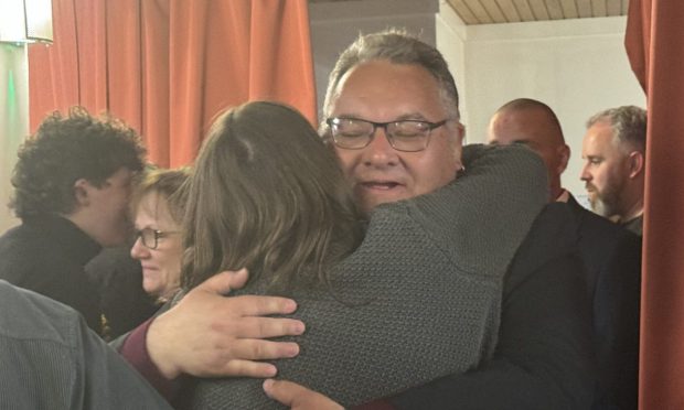 Graham Leadbitter hugs SNP supporters.
