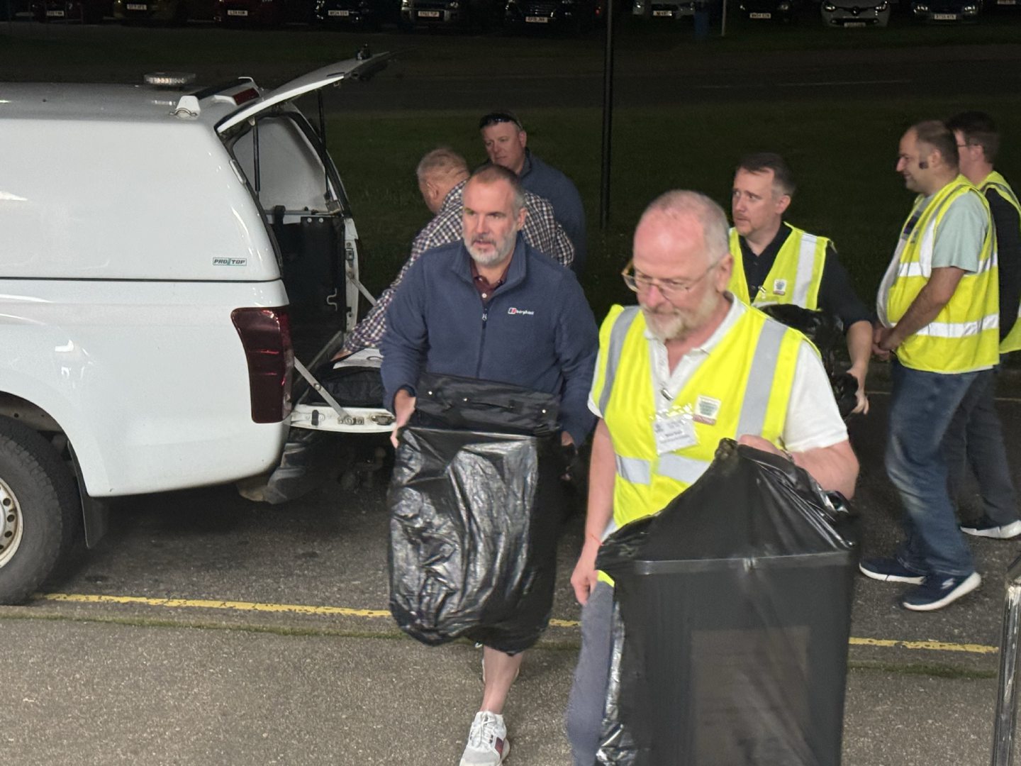 The last ballots being taken from a car and into the town hall