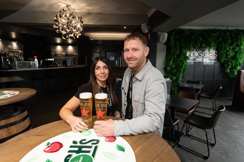 Bar owners Phil and Katie Witton with some pints in Foggies