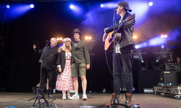 Allan Innes and Vicky Weaver read their vows on stage during Nathan Evans' performance at Belladrum Festival last night. Image: Jason Hedges