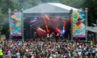 a crowd stands before a stage at Belladrum