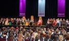 Purple banners hang down on the stage during RGU graduations.