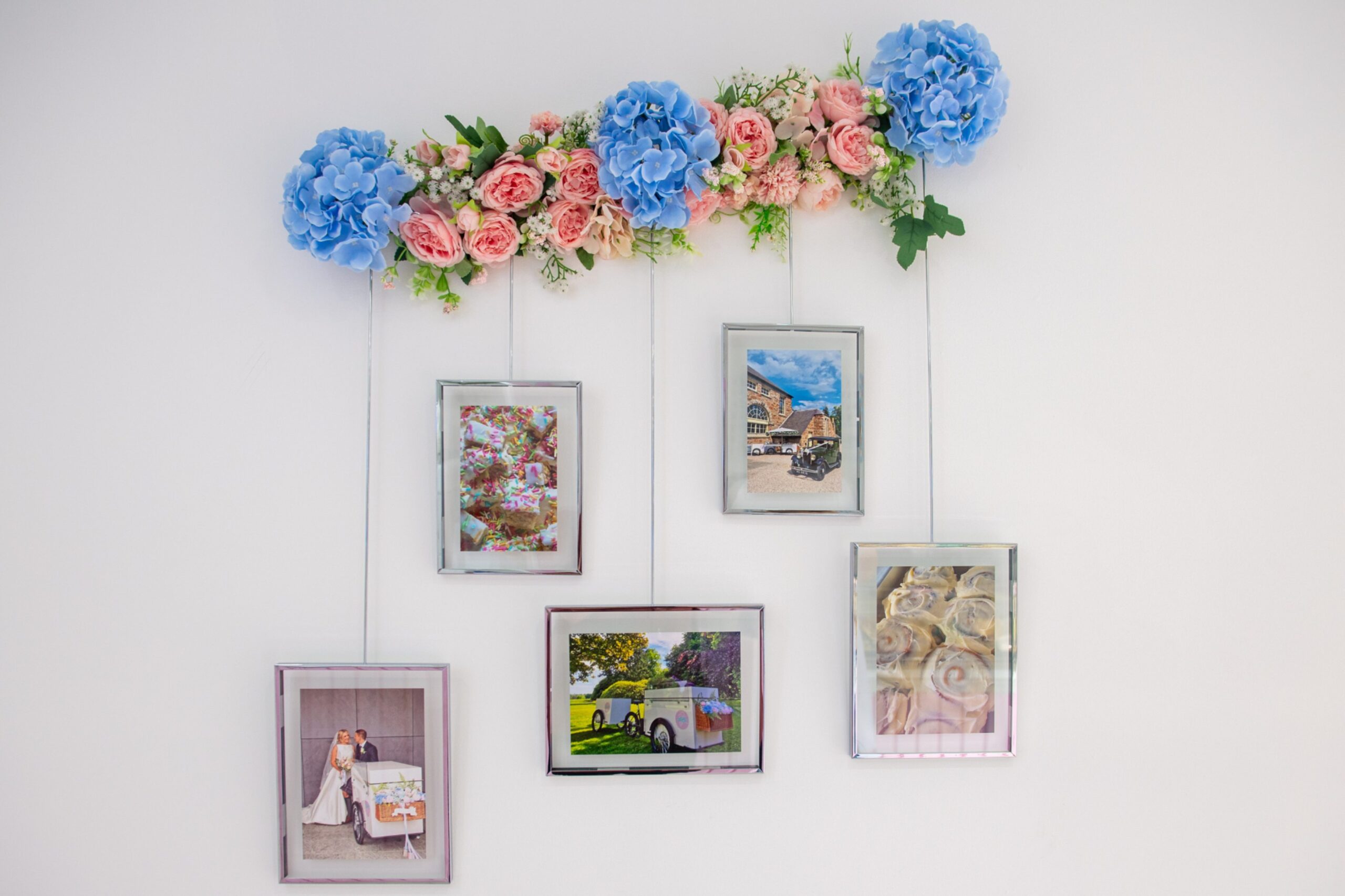 Some of the photos on the wall with floral decorations