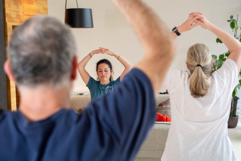 Tina Faulkner Elders instructing a qigong class for people with cancer in Maggie's Aberdeen