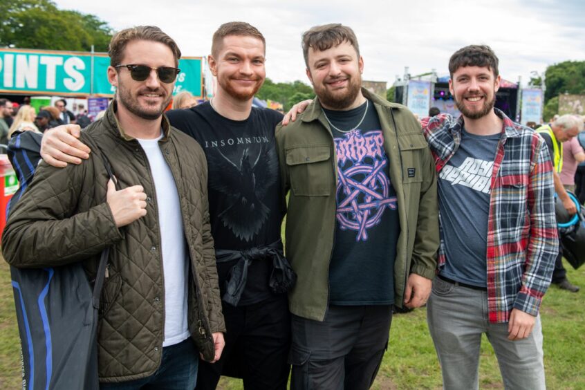 Four men posing for camera