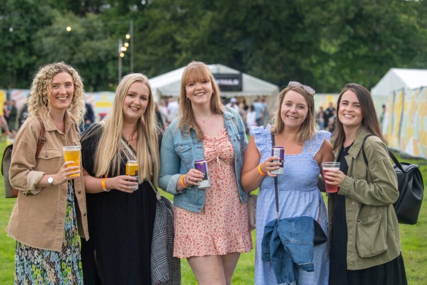 Five women posing for the camera