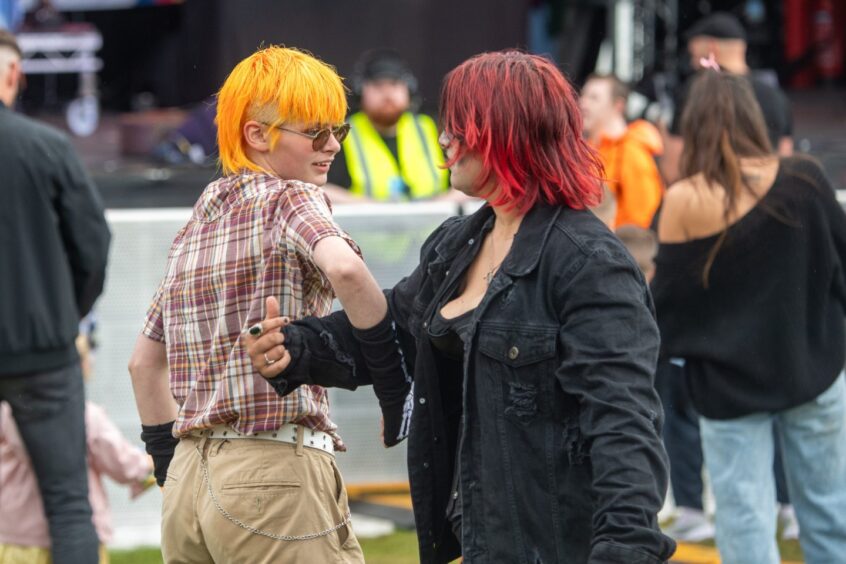 Two people dancing in front of the festival main stage 