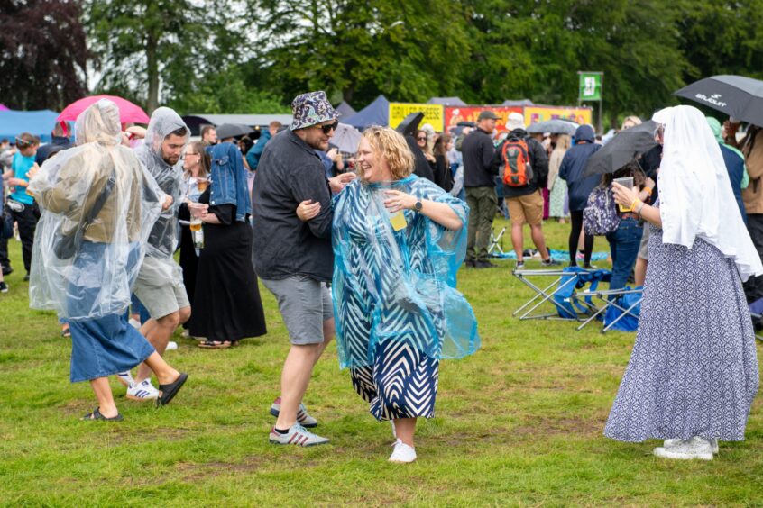 People dancing in the rain 