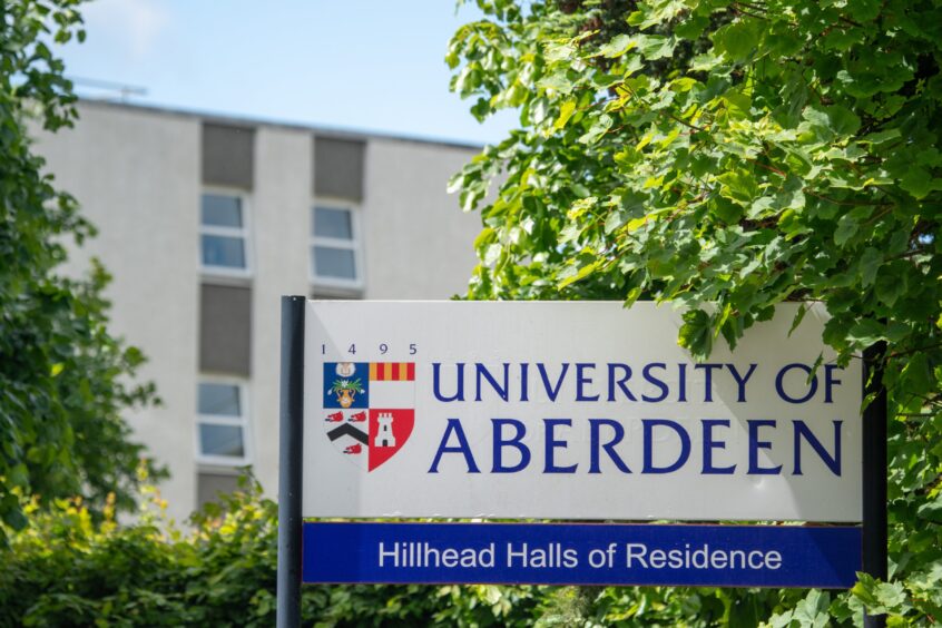 Aberdeen University sign with Hillhead in the background