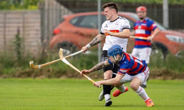 Lovat's Martin Mainland with James Falconer (Kingussie) in last season's Macaulay Cup semi-final. Image: Neil G Paterson.