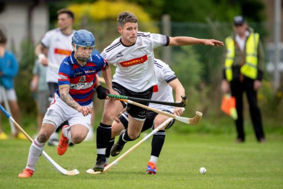 Kingussie's James Falconer (Left) with Daniel Grieve (Lovat).  Lovat v Kingussie in the Artemis MacAulay Cup Semi Final, played at Braeview Park, Beauly.