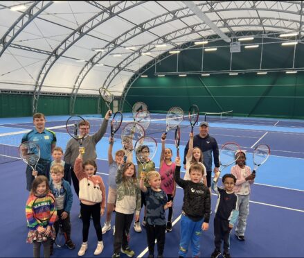 Lewis Simpson (back left), assistant coach at Moray Sports Centre, and CEO Iain Stokes (back right) with children from the centre's summer holiday activity camps.