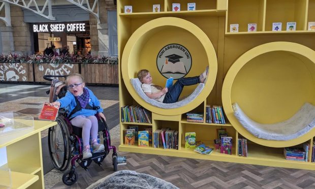 Calla and Ailith enjoy the library area.