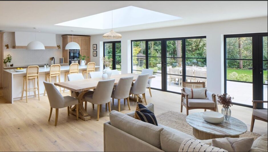 Open plan kitchen dining and lounge area flooded with natural light.