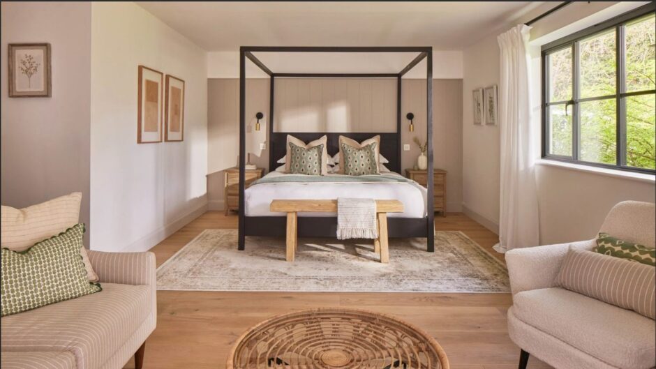 Four poster bed in large open plan bedroom.