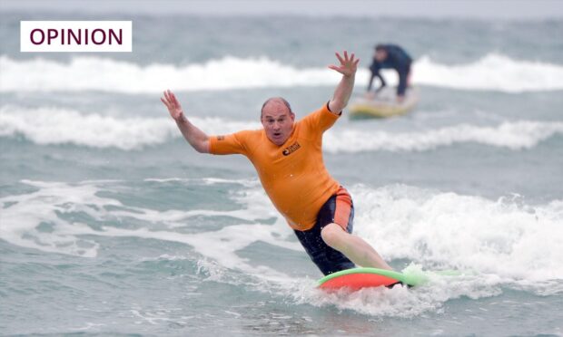 Sir Ed Davey of the Lib Dems goes surfing as one of several campaign stunts. Image: PA.