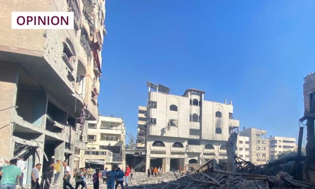 Palestinians inspect the Holy Family School, which shelters displaced people, after it was hit in an Israeli strike. Image: APAImages/Shutterstock