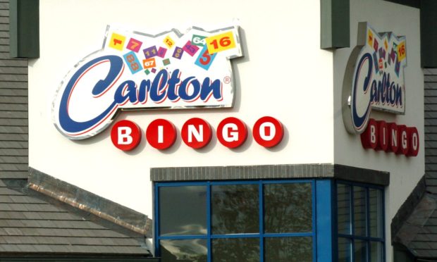 Carlton Bingo sign on the side of white building tower on Inverness hall.