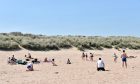 People enjoying the sunny weather on Newburgh Beach,